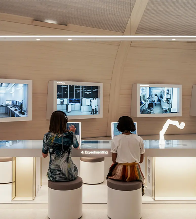 people-observing-interactive-exhibits-in-the-novartis-pavillon