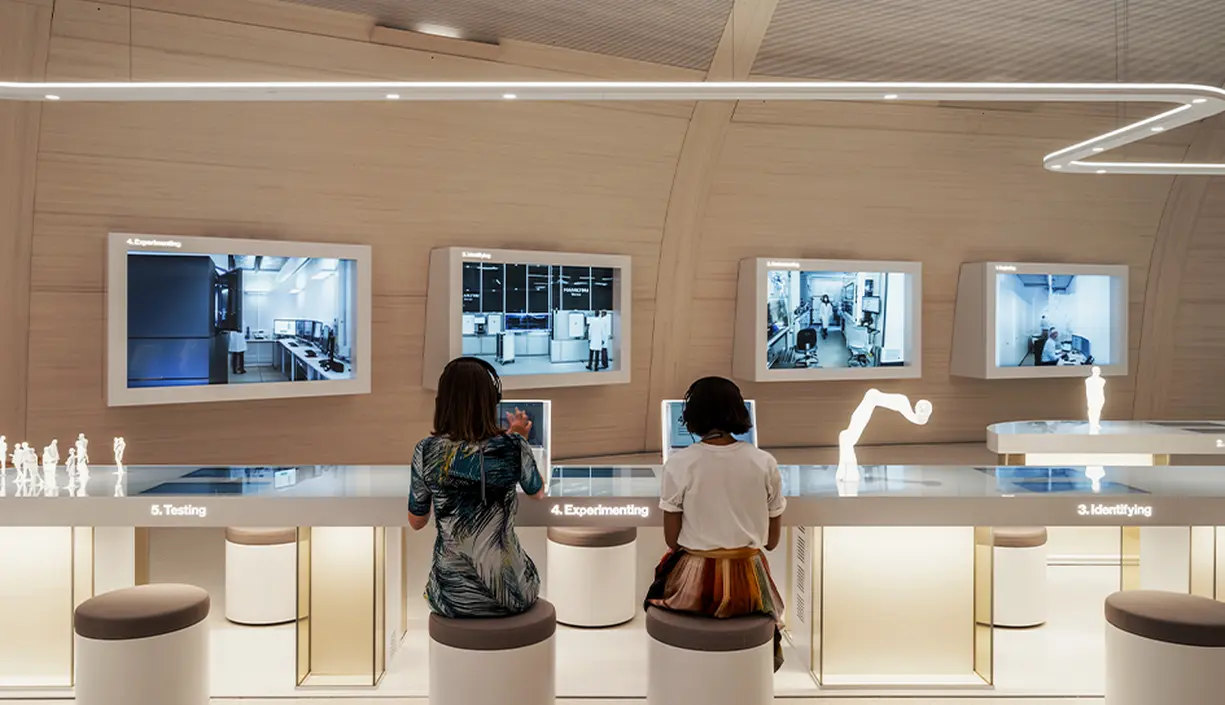 people-observing-interactive-exhibits-in-the-novartis-pavillon